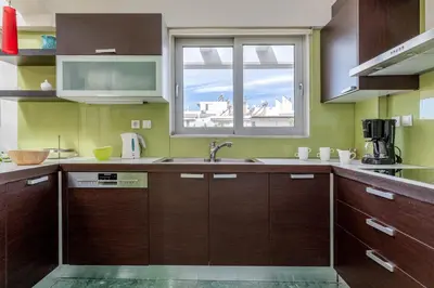 a kitchen with a sink and a window at Elvita Athens Sea View Maisonette in Athens