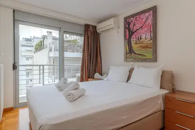 a bedroom with a bed with two stuffed animals on it at Elvita Athens Sea View Maisonette in Athens