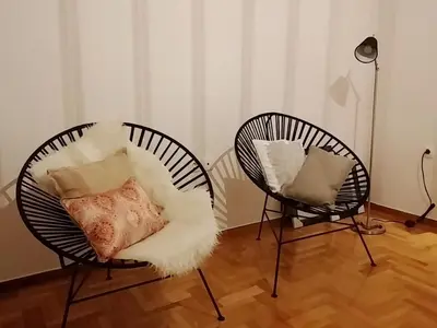 two chairs with pillows on them in a room at New stylish Kolonaki flat in Athens