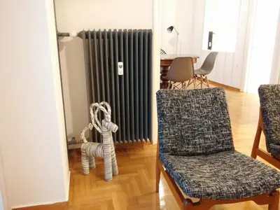 a living room with a radiator and a chair at New stylish Kolonaki flat in Athens