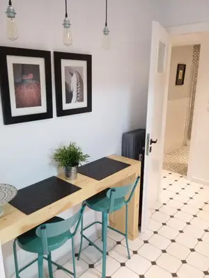 a kitchen with a table and two blue chairs at New stylish Kolonaki flat in Athens