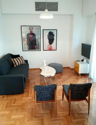 a living room with a couch and a table at New stylish Kolonaki flat in Athens
