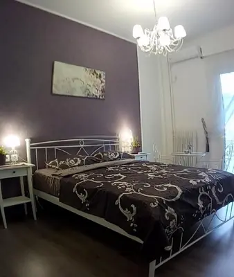 a bedroom with a bed and a chandelier at Apartment 