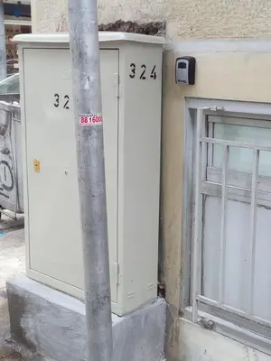 a pole with numbers on it next to a garage at Apartment 
