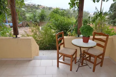 a small table and two chairs on a patio at Vagia Beach Apartments, Aegina Island in Vaia