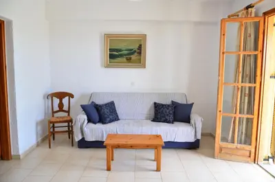 a living room with a couch and a table at Vagia Beach Apartments, Aegina Island in Vaia