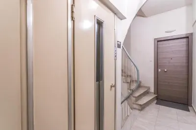 a hallway with a door and stairs in a house at HiEnd 4th floor 1bdr in Athens