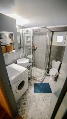 a bathroom with a shower and a washing machine at D16 Athens Apartment - 5' mins to Petralona Metro in Athens