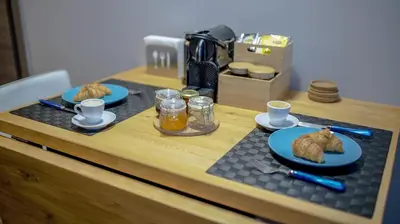 a table with two plates of food and drinks on it at D16 Athens Apartment - 5' mins to Petralona Metro in Athens