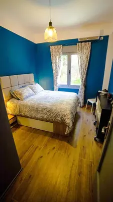 a bedroom with a bed with blue walls and a window at D16 Athens Apartment - 5' mins to Petralona Metro in Athens