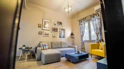 a living room with a couch and a yellow chair at D16 Athens Apartment - 5' mins to Petralona Metro in Athens