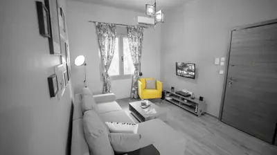 a living room with a couch and a yellow chair at D16 Athens Apartment - 5' mins to Petralona Metro in Athens