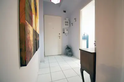 a hallway with a painting on the wall and a dresser at Cozy Flat in Heart of Acropolis in Athens