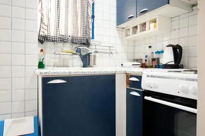 a kitchen with blue cabinets and a sink at Cozy Flat in Heart of Acropolis in Athens