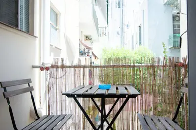 a small table and two chairs on a balcony at Cozy Flat in Heart of Acropolis in Athens