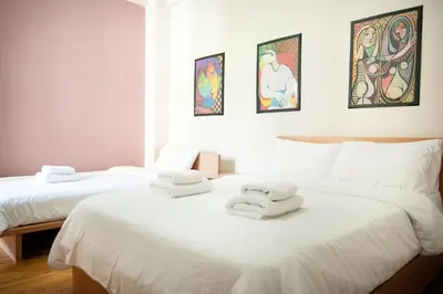 two beds with towels on top of them in a room at Cozy Flat in Heart of Acropolis in Athens