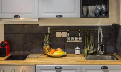 a kitchen counter with a bowl of fruit and a sink at A Gift in the Heart of Monastiraki A in Athens