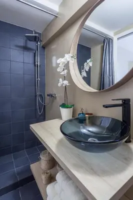 a bathroom with a sink and a mirror at A Gift in the Heart of Monastiraki A in Athens