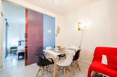 a dining room with a white table and chairs at A Gift in the Heart of Monastiraki A in Athens