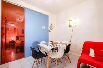 a dining room with a white table and chairs at A Gift in the Heart of Monastiraki A in Athens