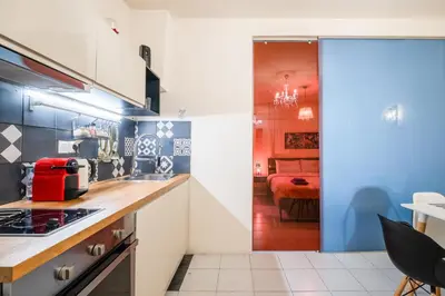 a kitchen with blue and white walls and a room at A Gift in the Heart of Monastiraki A in Athens
