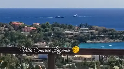 a view of the ocean from a balcony of a resort at Villa Sunrise Lagonisi in Lagonissi