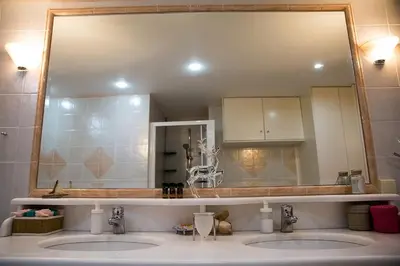 a bathroom with two sinks and a large mirror at Villa Sunrise Lagonisi in Lagonissi