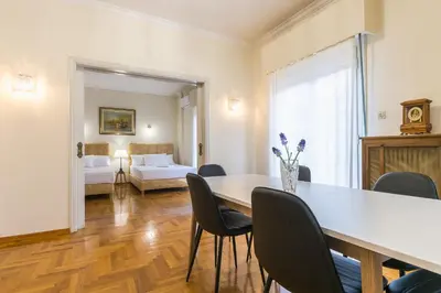 a dining room with a table and chairs at Victoria Queens Paradise Apartments in Athens
