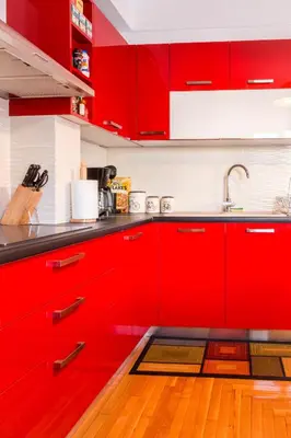 a kitchen with red cabinets and a sink at Martin’s Akropolis loft in Athens