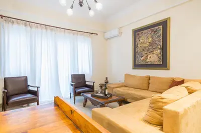 a living room with a couch and two chairs at Family House next to Acropolis in Athens