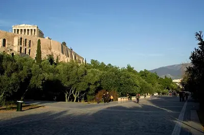 a street in front of a building with trees at Family House next to Acropolis in Athens