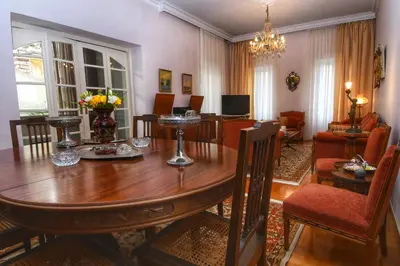 a dining room with a table and a living room at Athens Authentic Elegance at Acropolis in Athens