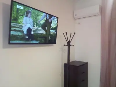 a flat screen tv hanging on a wall at New studio next to metro for 2 people in Athens