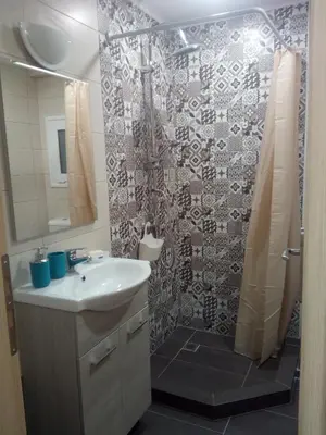 a bathroom with a sink and a shower at New studio next to metro for 2 people in Athens