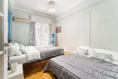 a bedroom with two beds and a window at 2BDR OlympianZeus Apt with Netflix in Athens