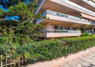 an apartment building with bushes in front of it at Athena's Comet in Athens