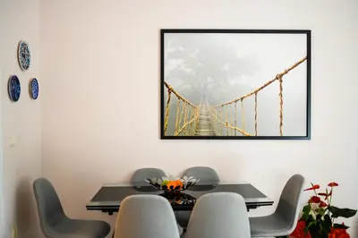 a dining room with a picture of a suspension bridge at Athena's Comet in Athens