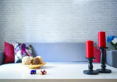 a table with two red candles and some toys on it at Athena's Comet in Athens