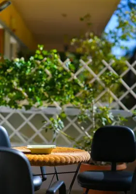 a table with chairs and a bowl on top at Athena's Comet in Athens