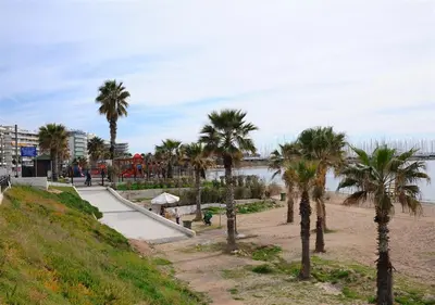 a park with palm trees next to a beach at Athena's Comet in Athens