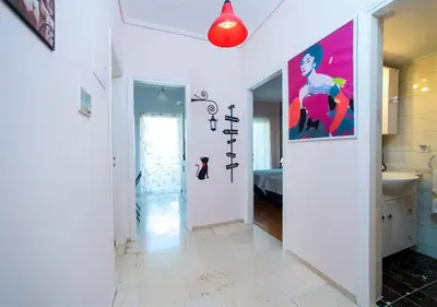 a hallway with a bathroom with a painting on the wall at Athena's Comet in Athens