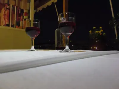 two glasses of red wine sitting on a table at Helen house in Athens