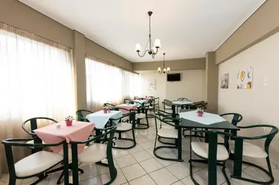 a row of tables and chairs in a restaurant at Filon in Piraeus