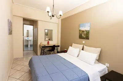 a bedroom with a large bed and a bathroom at Filon in Piraeus