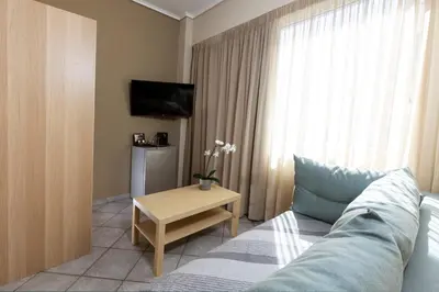 a living room with a couch and a tv and a table at Filon in Piraeus