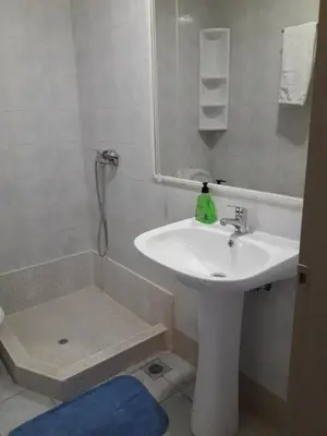 a bathroom with a sink and a shower with a mirror at Filon in Piraeus