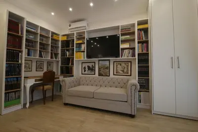 a living room with a couch and a tv at Luxurious Athenian Apartment in Athens