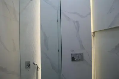 a shower with a glass door in a bathroom at Luxurious Athenian Apartment in Athens