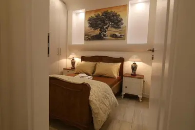 a bedroom with a bed and a painting on the wall at Luxurious Athenian Apartment in Athens