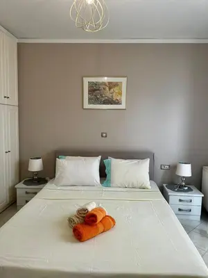 a bedroom with a bed with two towels on it at Piraeus Lux Secret in Piraeus